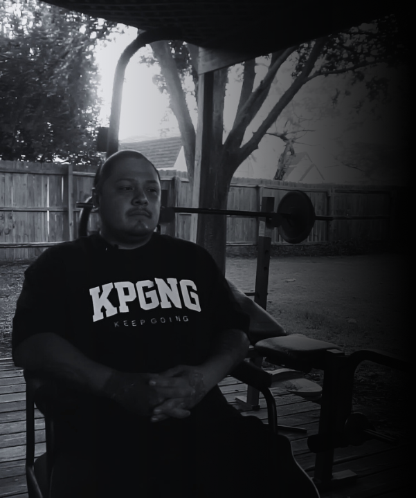 Person sitting outdoors with text overlay about 'Rock Bottom to Redemption' and KPGNGBRAND.