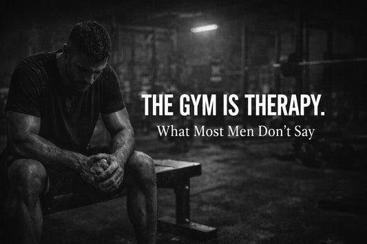 Man sitting alone in a dark gym after workout representing mental health, discipline, and how the gym is therapy for men